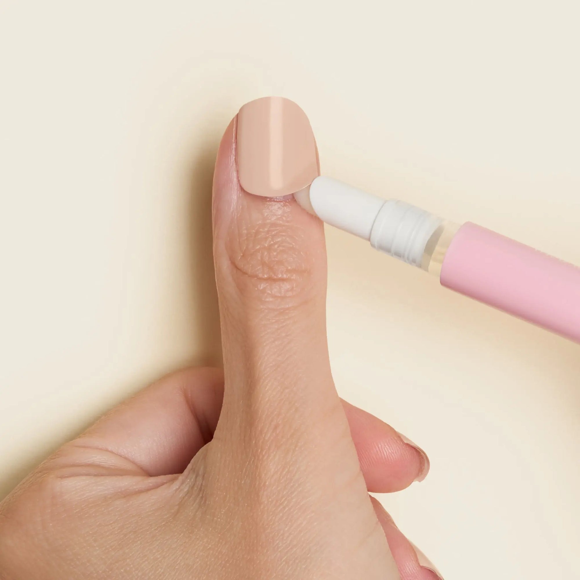 mesme Remover Pen — for all wraps — applying oil around the nail edge before removal (in use)