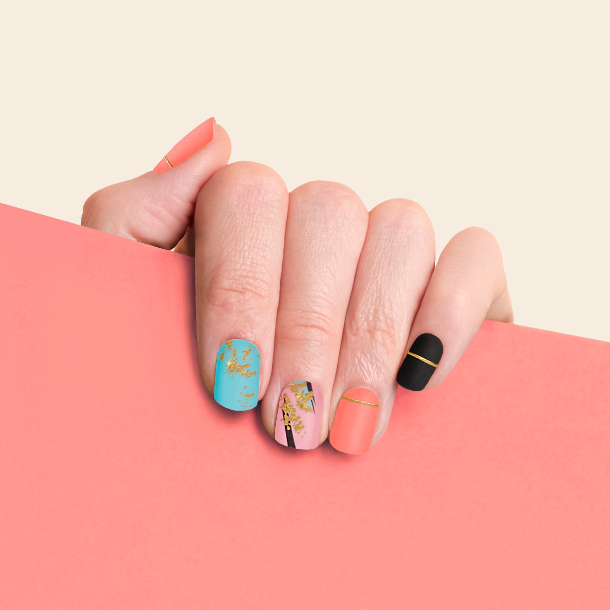 mesme Yayoi Turquoise, Coral, Pink, and Black 3+ Day UV-Free Gel Nail Wraps On Hand